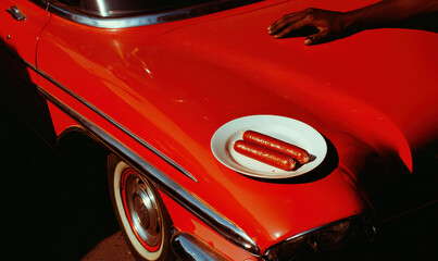 Chic Retro Lifestyle: Vintage Red Car Detail with Sunlit Hood Embodies Classic Casual Style and Urban Aesthetic
