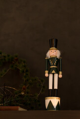 A charming wooden nutcracker soldier with green and gold accents adds a touch of tradition to the...