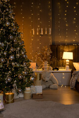 A glowing Christmas tree adorned with silver ornaments and ribbons sets a magical holiday tone