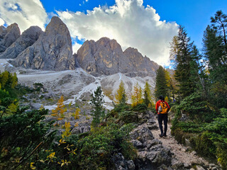 Discover the serene charm of a rustic cabin nestled by the Dolomites' majestic peaks in Italy