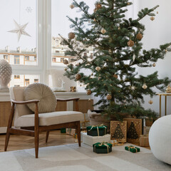 Festive living space with a decorated tree, cozy chair, and natural holiday decor. A perfect setting for holiday gatherings.