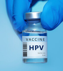 A doctor holds a vial of the HPV vaccine. Experimental HIV vaccine vial for immunization against HPV disease.