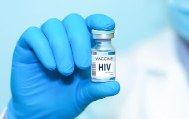 A doctor holds a vial of the HIV vaccine. Experimental HIV vaccine vial for immunization against HIV disease.