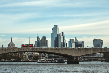 View from a boat of Waterloo Bridge, and London's modern architecture. A double-decker bus passes over this bridge, London.