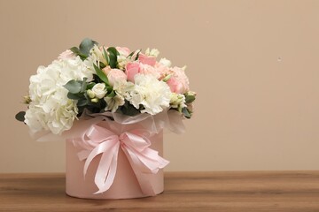 Bouquet of beautiful flowers on wooden table, space for text