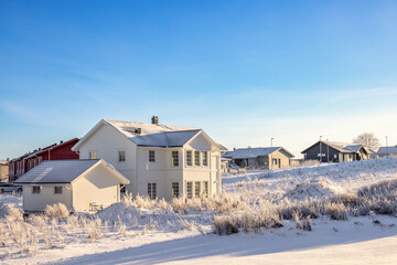 Newly built house in a residential area a sunny winter day with snow