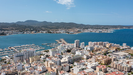 Aerial drone photo of a beach in the town of Sant Antoni de Portmany on the island of Ibiza in the Balearic Islands Spain showing the boating harbour and the beach known as Playa de San Antonio
