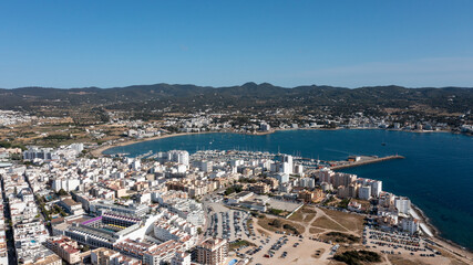 Aerial drone photo of a beach in the town of Sant Antoni de Portmany on the island of Ibiza in the Balearic Islands Spain showing the boating harbour and the beach known as Playa de San Antonio