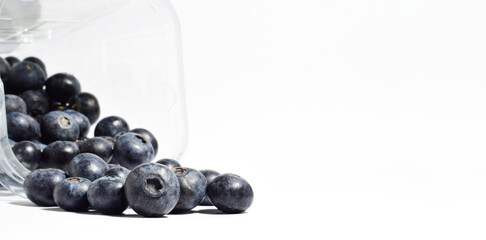 Close up, blueberries, with a contribution of beneficial nutrients for our body, white background and copy space. Elongated format.