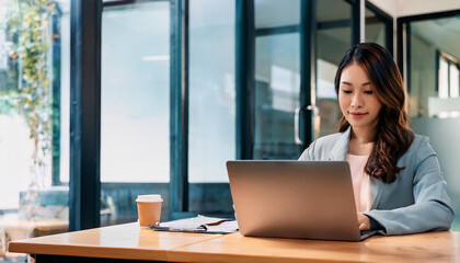 Young woman working from home using laptop in office.