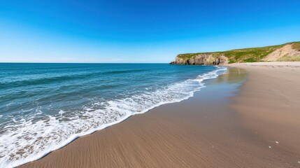 A serene beach scene with gentle waves, golden sand, and a clear blue sky, framed by lush green cliffs.