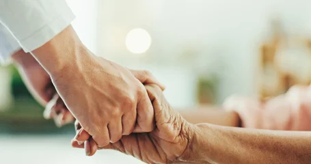 Nurse, holding hands and elderly care with empathy for love, assisted living or support at old age home. Closeup, people or touch with sympathy for healthcare, nursing help or assistance at house