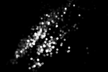 White gray blurred bokeh lights on black background