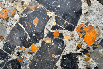 Colorful geological rock texture with orange and black patterns