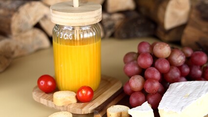 Artisan cheese, juicy grapes, crusty bread, and orange juice create farmhouse gourmet selection, showcasing fresh, high-quality ingredients, perfect for farm-to-table dining and gourmet promotions.