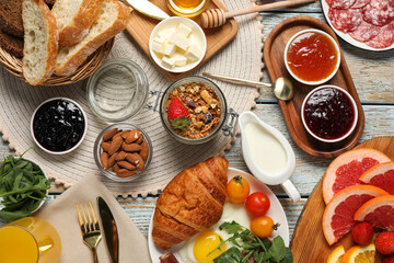 Different tasty food served for brunch on white wooden table, flat lay