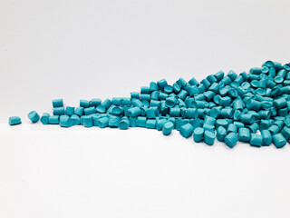 Bright blue masterbatch granules on white background, polymer carrier of color pigment in plastic industry. Perfect for plastic company catalog design.