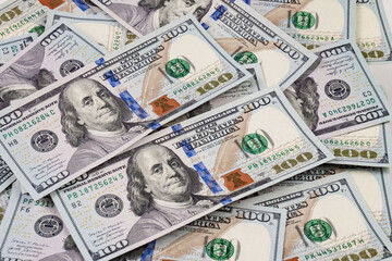 heap of one hundred dollar bills as background, close-up