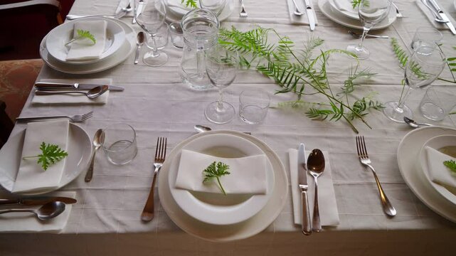 Table setting with tablecloth and dishes before guests arrive