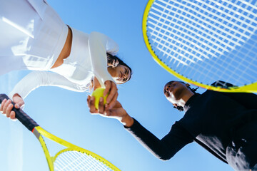 Tennis, handshake and low angle of friends on court for teamwork