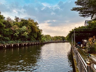 Evening view of a canal near a temple in Thailand.