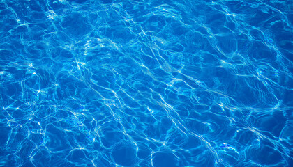Fototapeta premium Vibrant Blue Swimming Pool Water With Ripples and Reflections From Top View