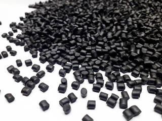 Fototapeta premium Black masterbatch granules on white background, polymer carrier of color pigment in plastic industry. Suitable for plastic company catalog design.