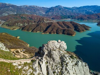 Aerial view of Lake Bovilla surrounded by majestic mountains. Albania