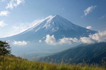 Fototapeta premium Majestic Mount Fuji rising above lush green hills on a clear sunny day