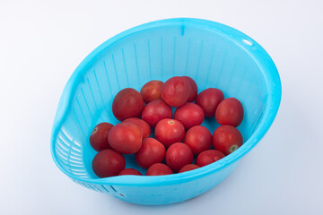 Wash cherry tomatoes in the basket