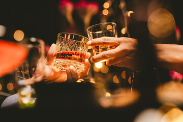 Alcohol and people hands for a night party to celebrate birthday or fun. Group of friends and drinking on the dance floor with shots.