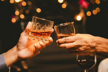 Alcohol and people hands for a night party to celebrate birthday or fun. Group of friends and drinking on the dance floor with shots.