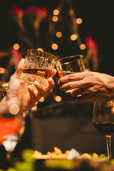 Alcohol and people hands for a night party to celebrate birthday or fun. Group of friends and drinking on the dance floor with shots.