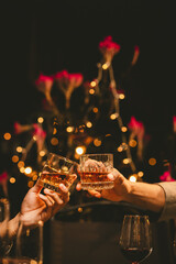 Alcohol and people hands for a night party to celebrate birthday or fun. Group of friends and drinking on the dance floor with shots.