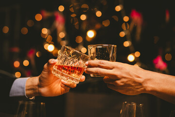 Alcohol and people hands for a night party to celebrate birthday or fun. Group of friends and drinking on the dance floor with shots.