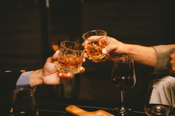 Alcohol and people hands for a night party to celebrate birthday or fun. Group of friends and drinking on the dance floor with shots.