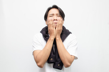 Young Asian Man Crying with a Sad Expression, Showing Deep Emotions