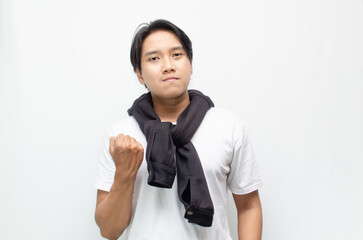 Happy and Surprised Young Asian Man in Casual Outfit Celebrating Victory