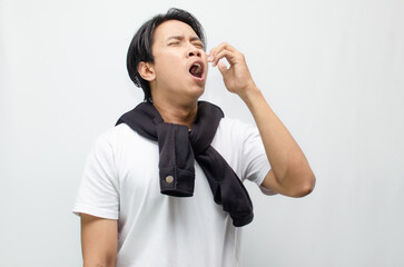 Young Asian Man Coughing and Showing Symptoms of Flu with Fever