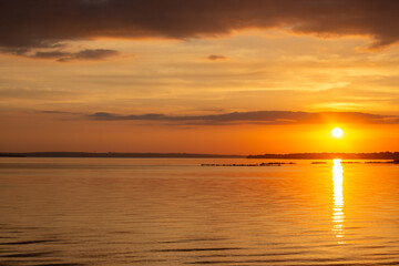 colorful background of the sunset on the sea, the horizon is a calm sky