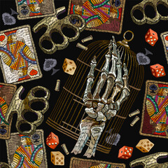 Obraz premium Embroidery playing cards, brass knuckles, golden bird cage and anatomical skeleton head. Seamless pattern. Street culture style. Fashion template for design. Dark gothic halloween art
