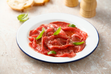 Traditional beef carpaccio with salt and pepper	