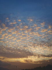 Mesmerizing Cloud Patterns at Sunset, A Captivating Display of Nature's Evening Beauty Amidst the Urban Landscape