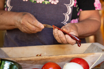 Preparing Mexican Mole Negro. Oaxaca chiles have to be cleaned, toasted on a comal over a flame and...