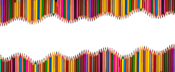 Many colored crayons arranged in a wavy rows with middle copy space for text, isolated on white background, education banner concept
