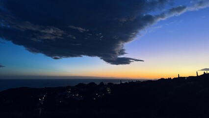 Gray cloud drifting in the sky at sunset, creating a dramatic atmosphere.