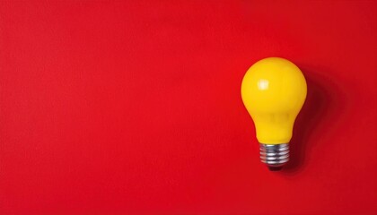 Yellow light bulb a red background, a flat lay banner design for a business concept 