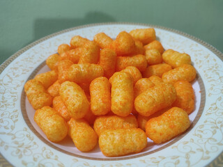 Crispy Golden Cheese Puffs Served on a Decorative Plate Perfect for Snack Lovers.