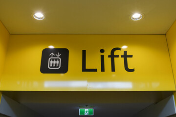 Large lift signage on a yellow background