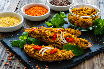 Tasty sandwiches with lentil pate on wooden table